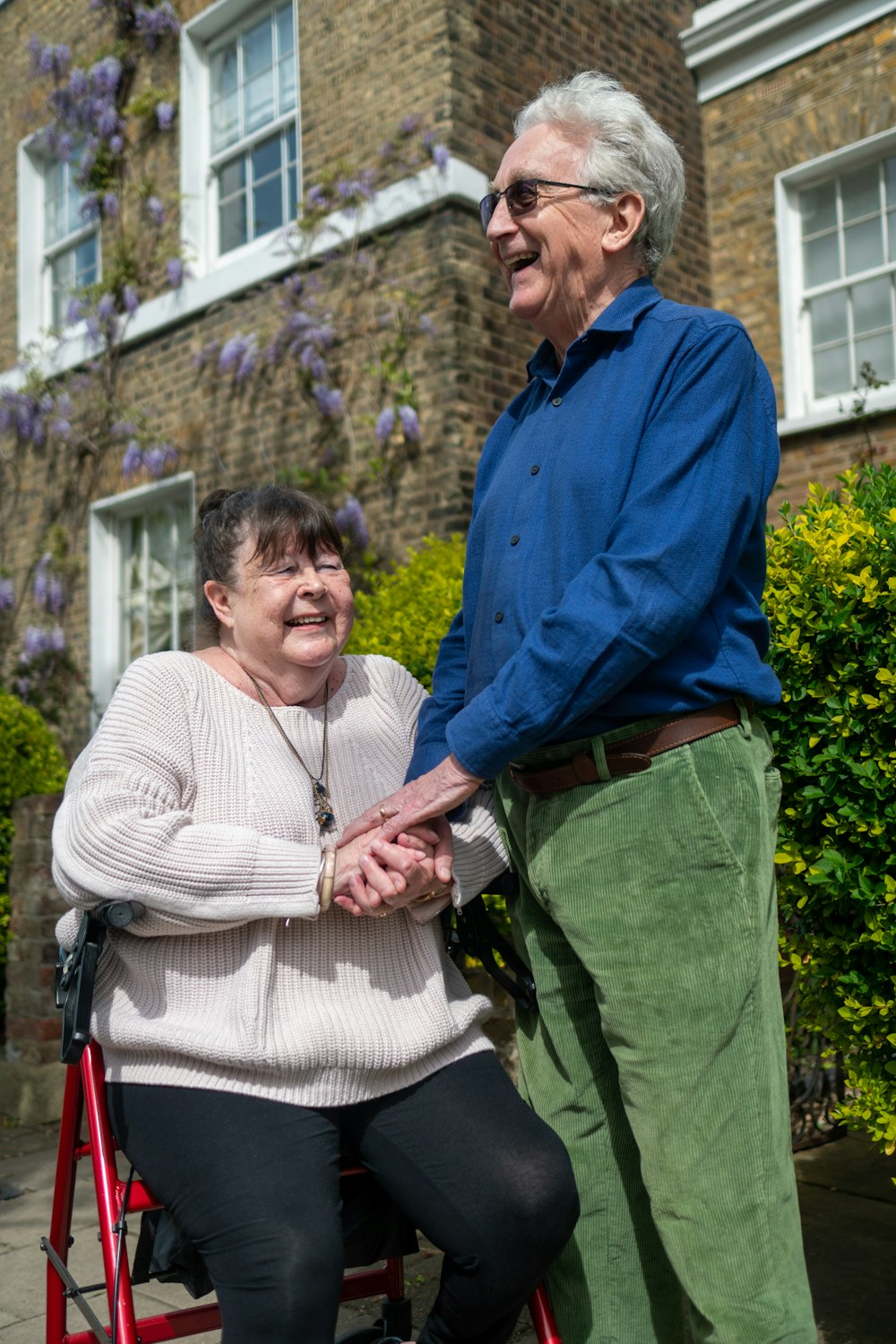 An older couple standing together outdoors